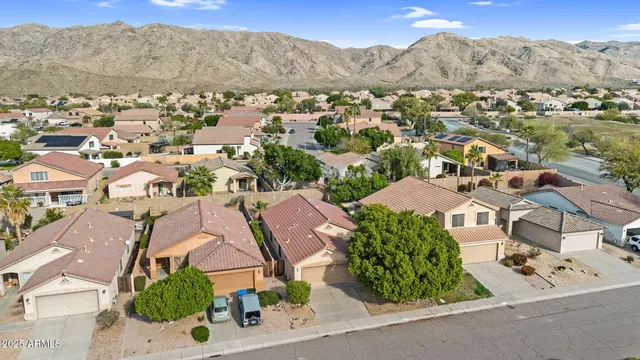 an aerial view of residential houses with outdoor space and street view
