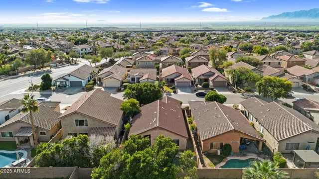 an aerial view of residential houses with outdoor space