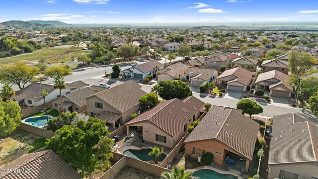 an aerial view of residential houses with outdoor space