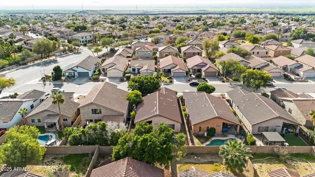 an aerial view of residential houses with outdoor space