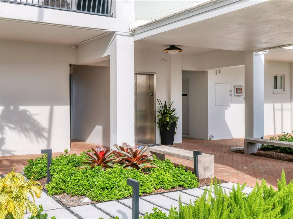 226 Golden Gate Point, Unit 44 Sarasota, FL 34236 - Photo 11 of 65 a front view of a house with a yard