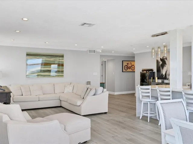 a kitchen with a sink and a stove top oven with wooden floor