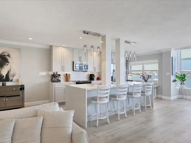 a kitchen with stainless steel appliances a sink stove and refrigerator