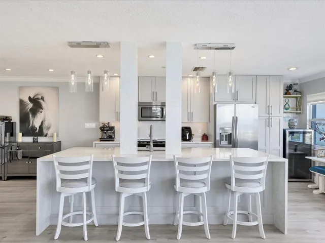 a dining room with furniture a chandelier and wooden floor
