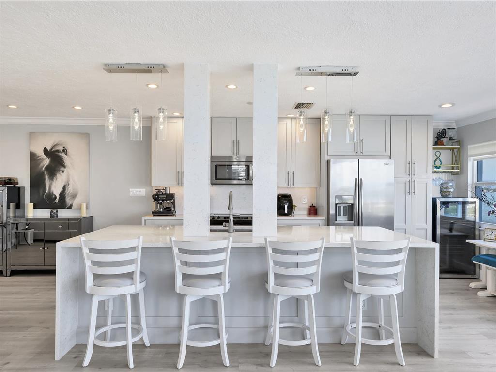 226 Golden Gate Point, Unit 44 Sarasota, FL 34236 - Photo 22 of 65 a dining room with stainless steel appliances kitchen island granite countertop a dining table and chairs