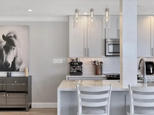 a view of a dining room with furniture large windows and wooden floor