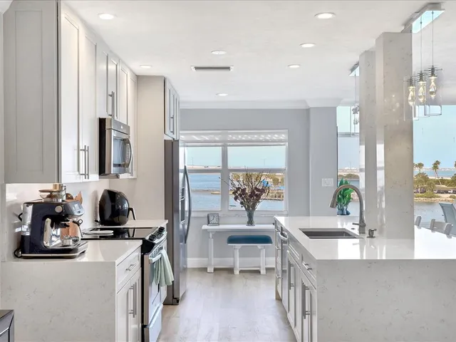 a dining room with furniture a large window and wooden floor