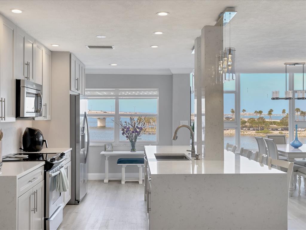 226 Golden Gate Point, Unit 44 Sarasota, FL 34236 - Photo 27 of 65 a living room with furniture a wooden floor and a large window