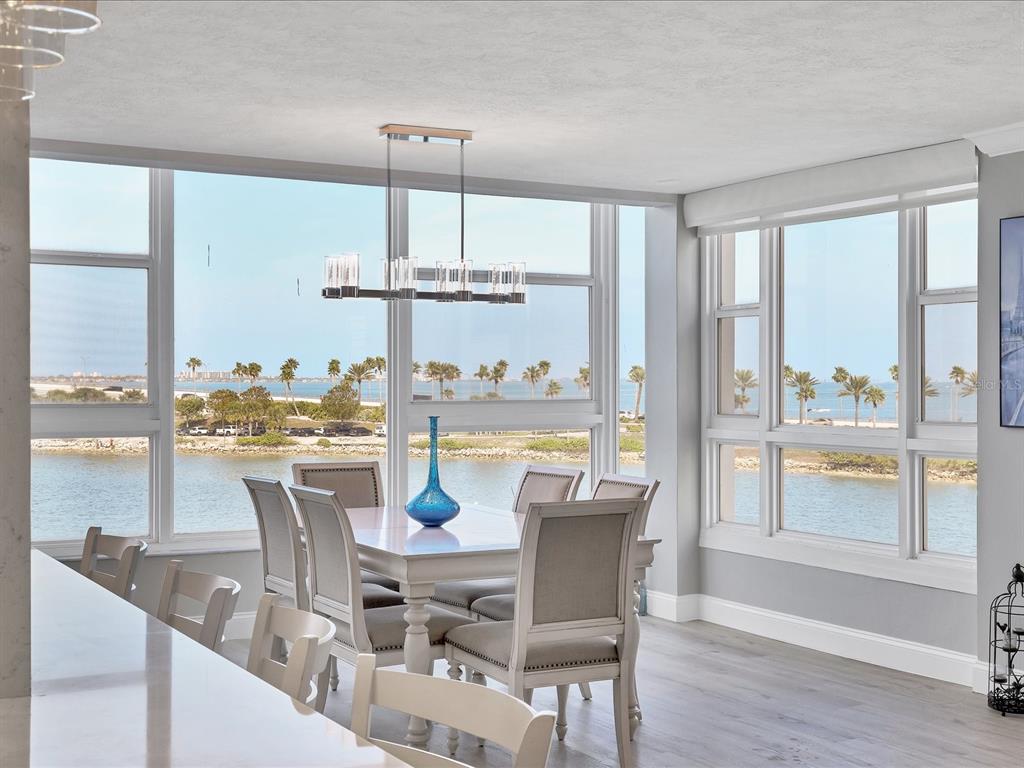 226 Golden Gate Point, Unit 44 Sarasota, FL 34236 - Photo 30 of 65 a dining room with furniture a chandelier and wooden floor