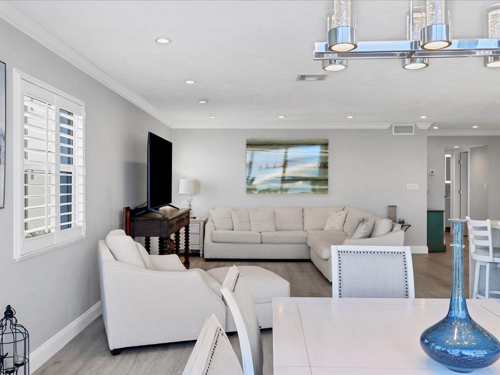 226 Golden Gate Point, Unit 44 Sarasota, FL 34236 - Photo 35 of 65 a living room with furniture and a flat screen tv
