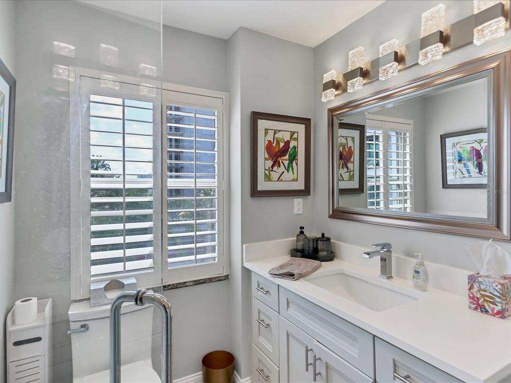 226 Golden Gate Point, Unit 44 Sarasota, FL 34236 - Photo 40 of 65 a bathroom with a sink and a window