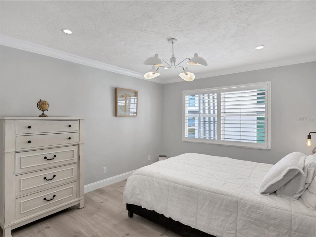 226 Golden Gate Point, Unit 44 Sarasota, FL 34236 - Photo 41 of 65 a bedroom with a bed and a dresser
