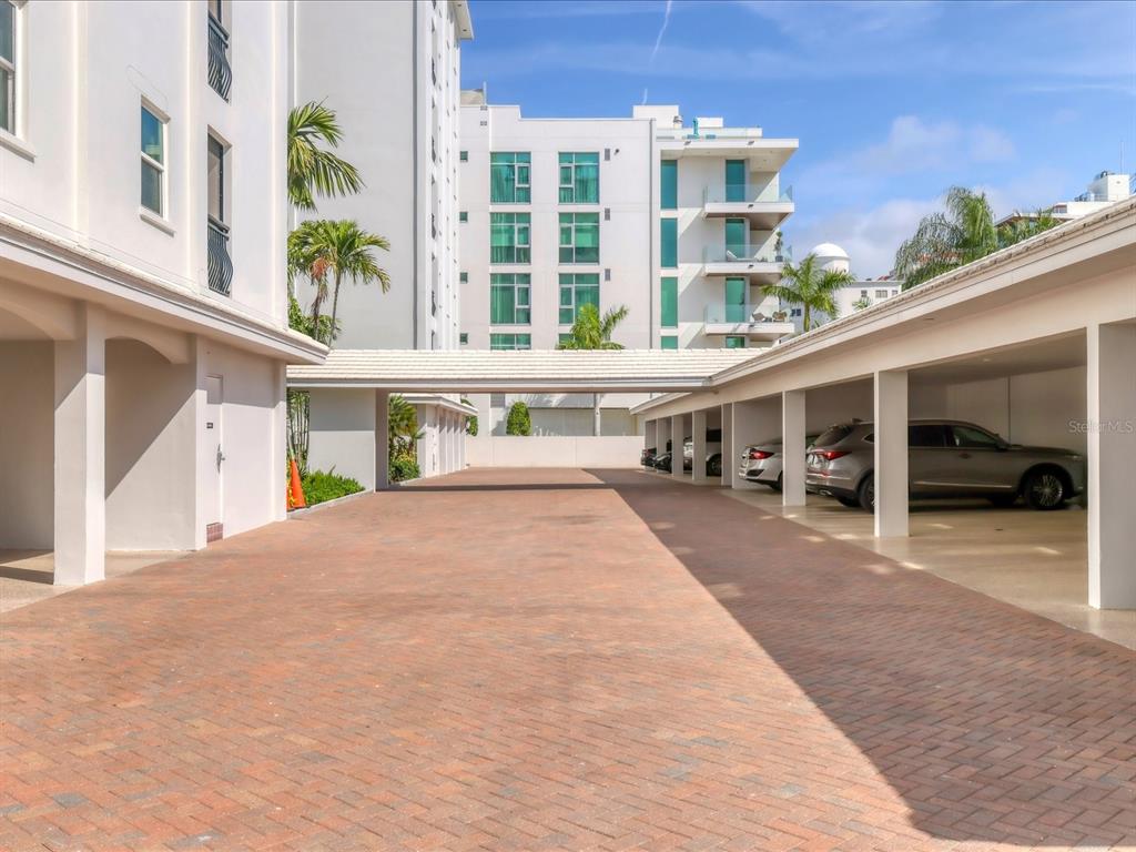 226 Golden Gate Point, Unit 44 Sarasota, FL 34236 - Photo 6 of 65 a front view of a building with glass windows and door
