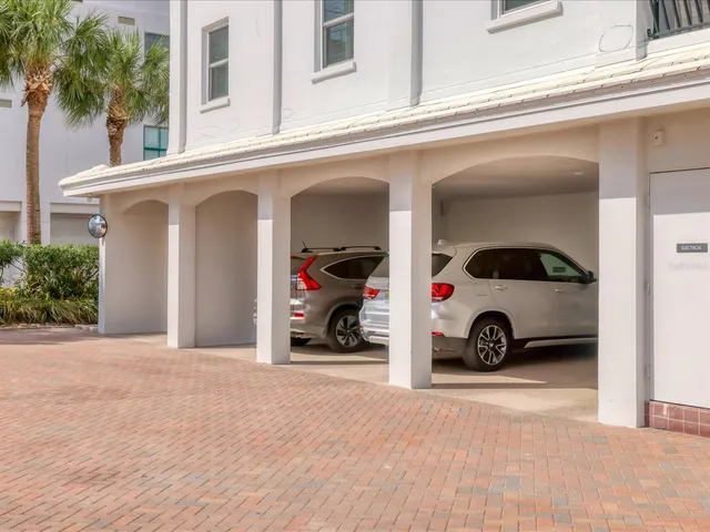 a hallway with wooden floor and a potted plant