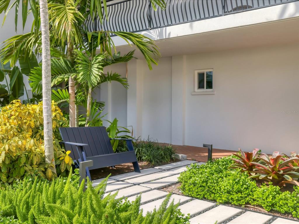 226 Golden Gate Point, Unit 44 Sarasota, FL 34236 - Photo 9 of 65 a backyard of a house with a garden and plants