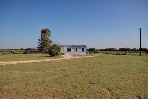 a front view of a house with a lake view