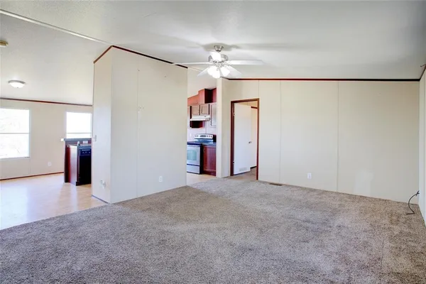 a view of a livingroom with a ceiling fan and window