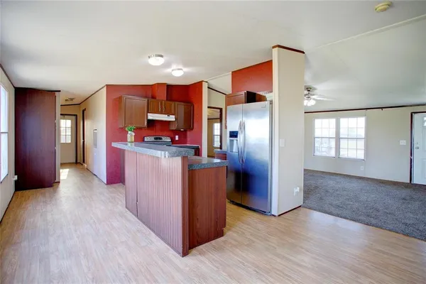 a kitchen with stainless steel appliances granite countertop a refrigerator and a stove