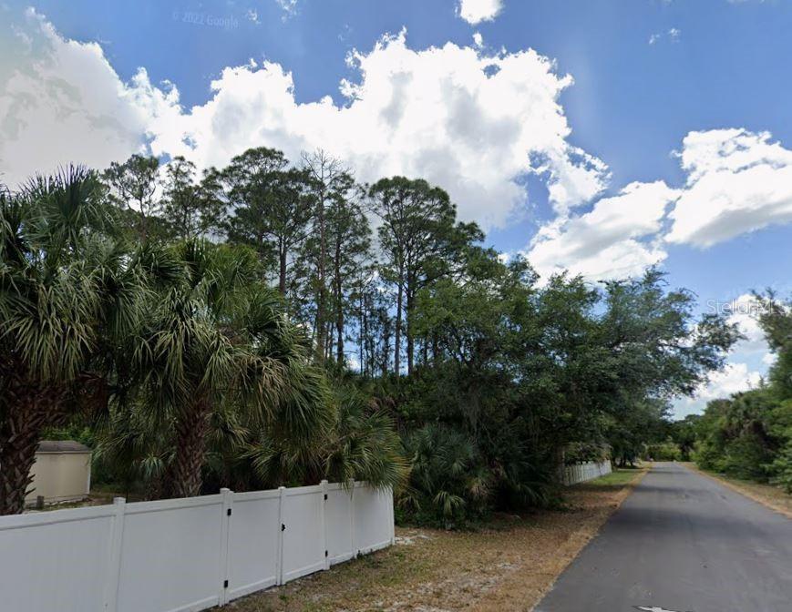 335 Orleans Street Port Charlotte, FL 33953 - Photo 2 of 2 a view of a street with a tree in back