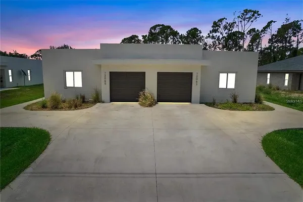 a large white building with a yard in front of it