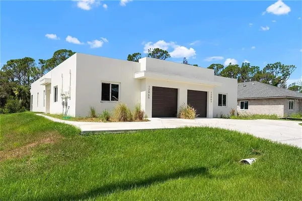 a front view of a house with a yard and garage