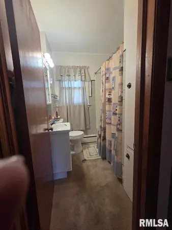 a view of kitchen with granite countertop a refrigerator and a sink