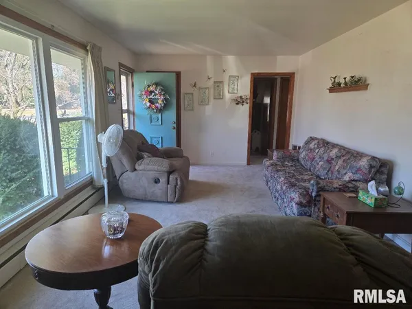 a living room with furniture and a large window