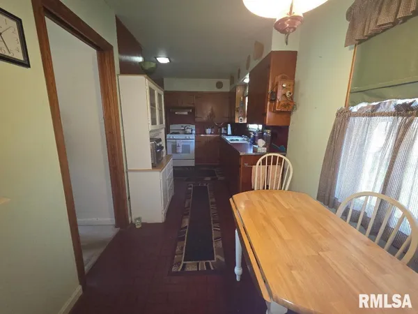 a view of a dining room with furniture and a chandelier