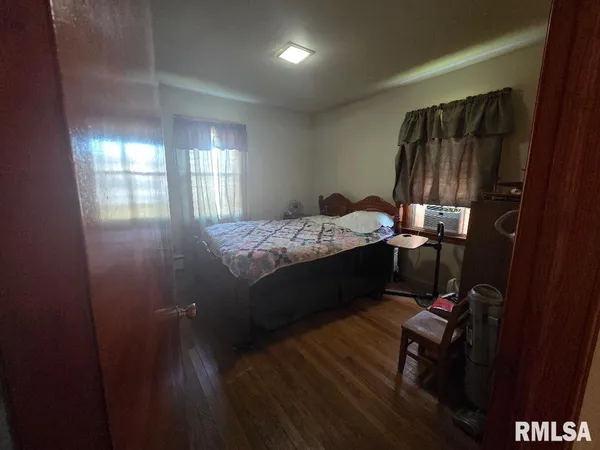 a bed room with a bed chair and a window