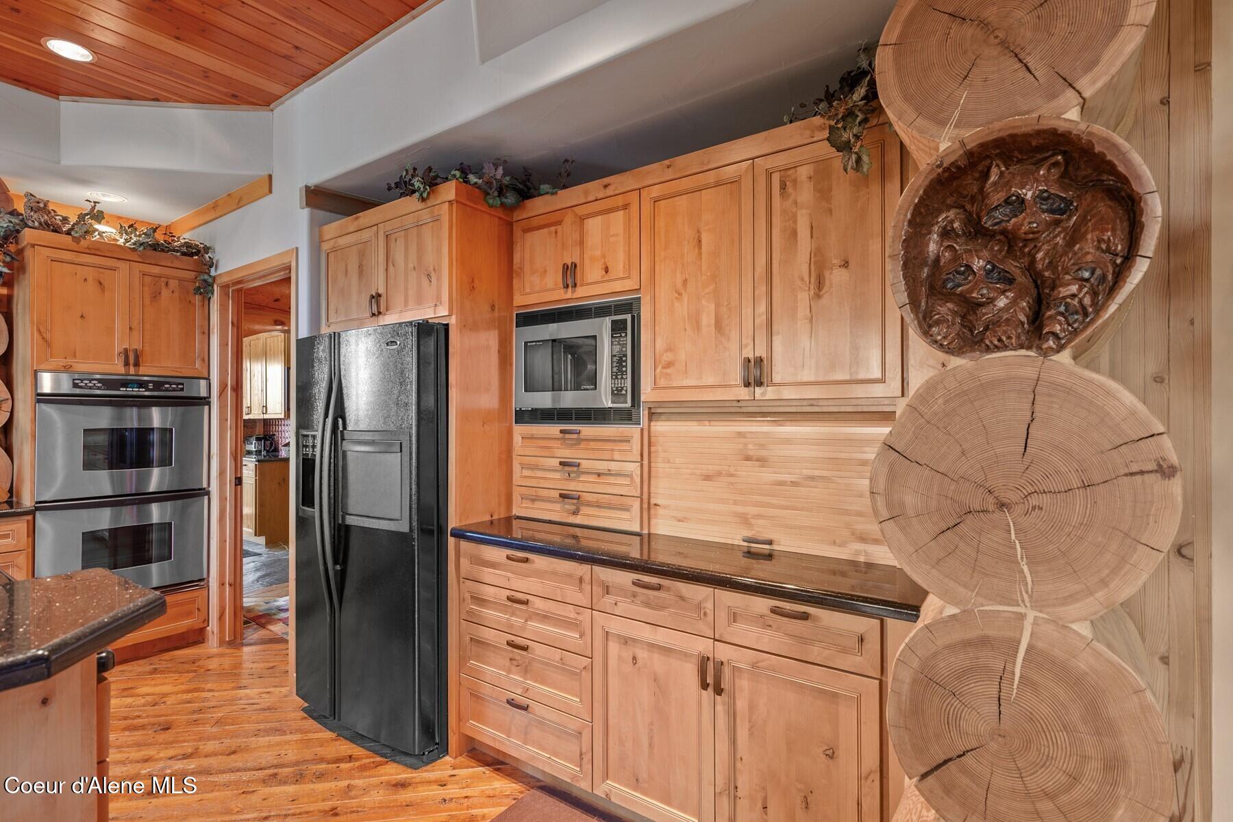 18869 South Trekker Woods Road Coeur D'Alene, ID 83814 - Photo 12 of 76 SS Appliances framed by Wood