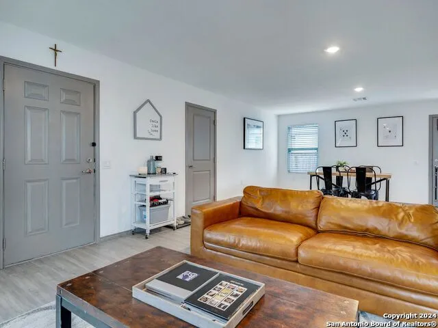 a living room with a couch and dresser