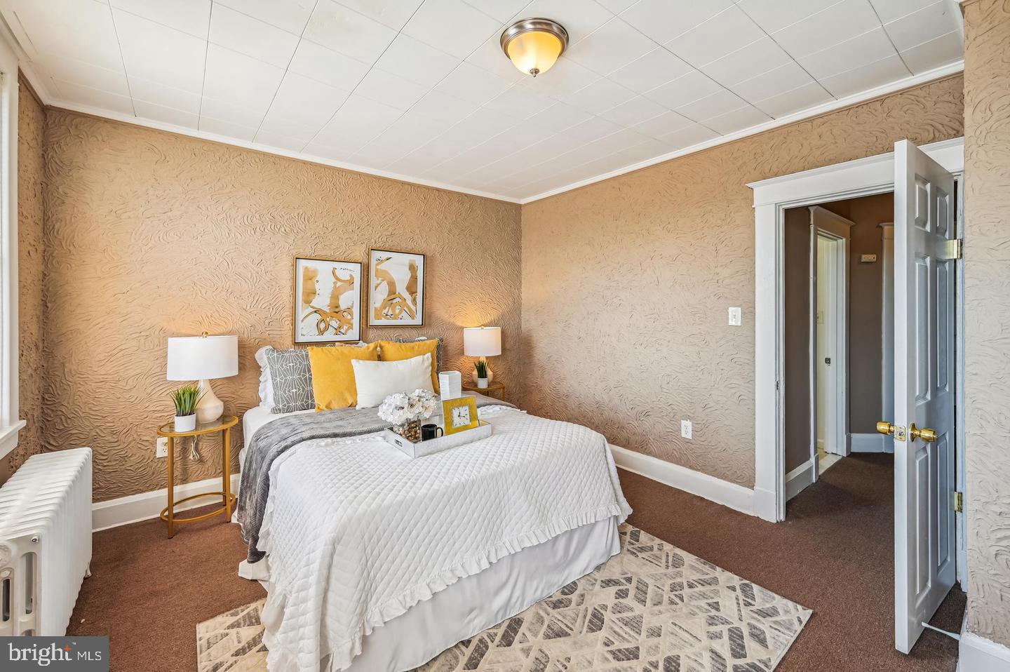 5632 Belair Road Baltimore, MD 21206 - Photo 15 of 32 a bedroom with a bed and wooden floor