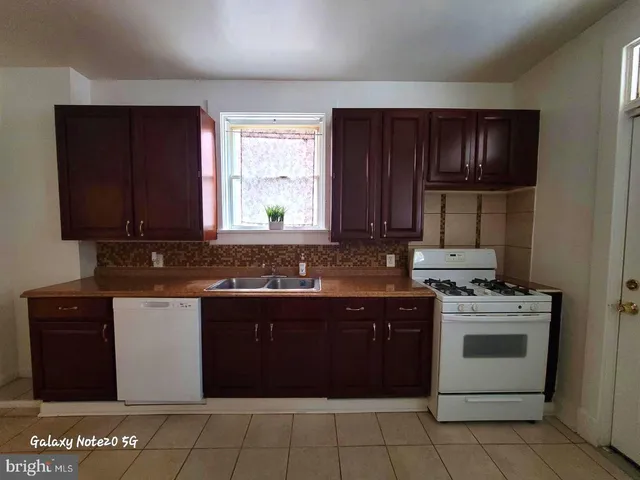 a kitchen with a stove sink and cabinets