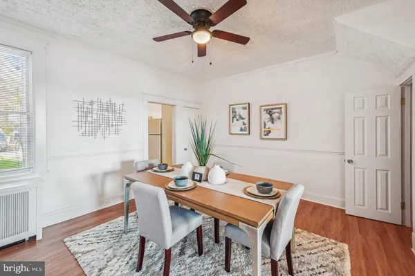 a dining room with furniture and wooden floor