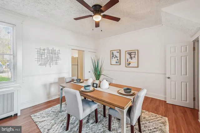 a dining room with furniture and wooden floor