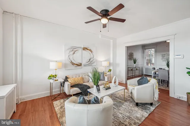 a living room with furniture and a wooden floor