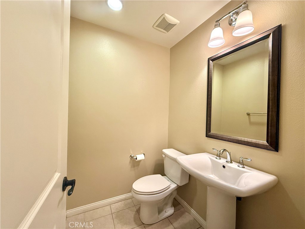 467 Raya Lane Brea, CA 92823 - Photo 14 of 30 a bathroom with a toilet sink and mirror