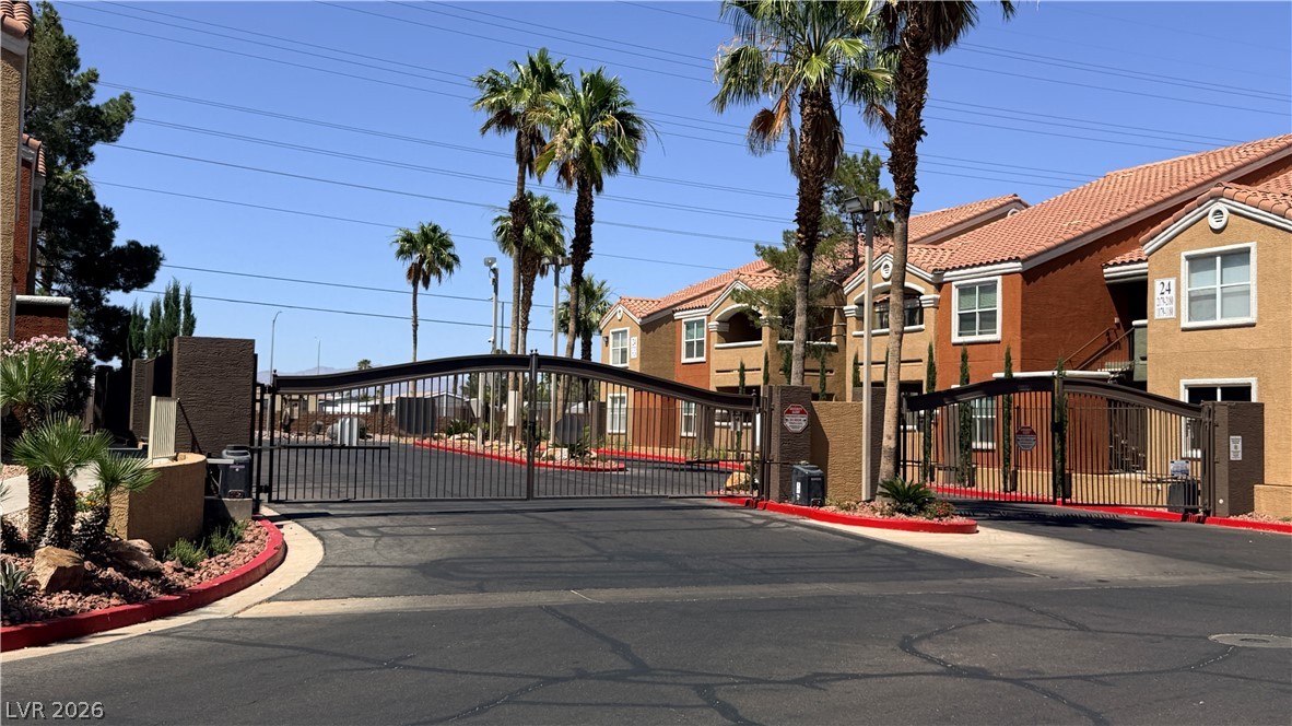Secure community entrance with an ornate iron gate.