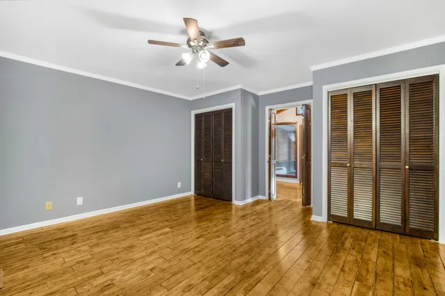 a view of an empty room with wooden floor