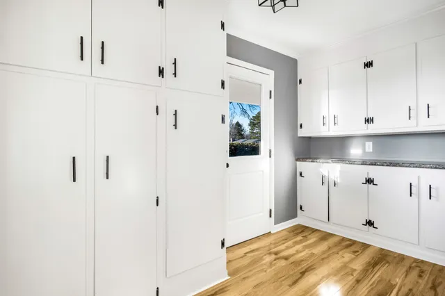 a view of a kitchen with white cabinets