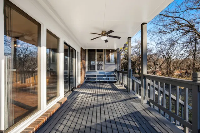 a view of a balcony with furniture and floor to ceiling window