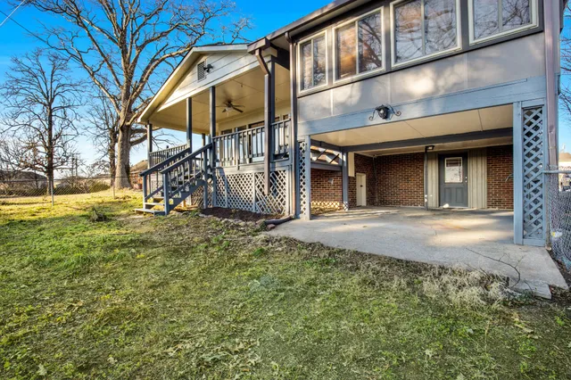 a view of an house with backyard and tree