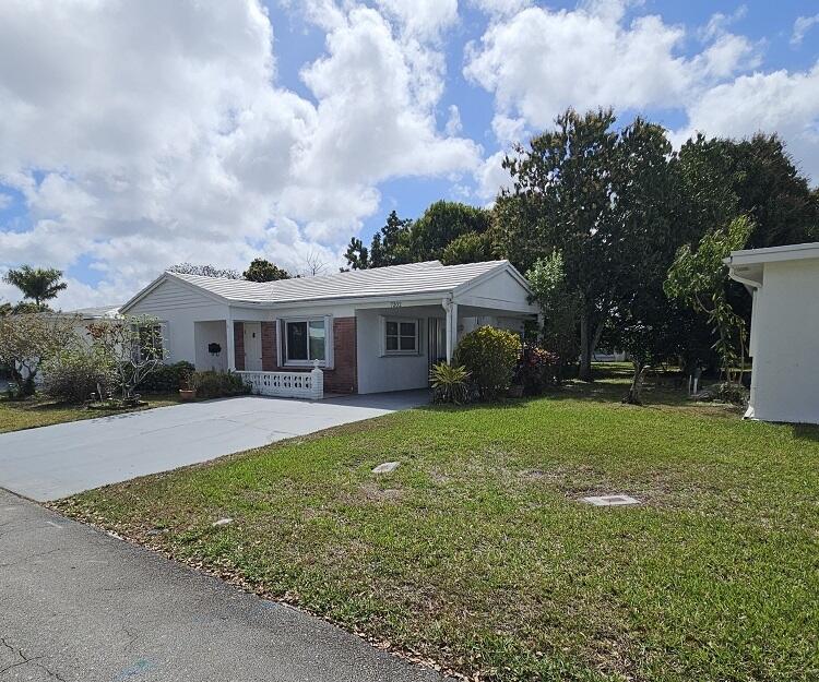 7202 Northwest 73rd Street Tamarac, FL 33321 - Photo 2 of 11 a front view of a house with garden