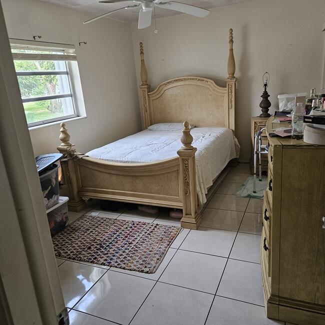 7202 Northwest 73rd Street Tamarac, FL 33321 - Photo 3 of 11 a bedroom with a bed and a window