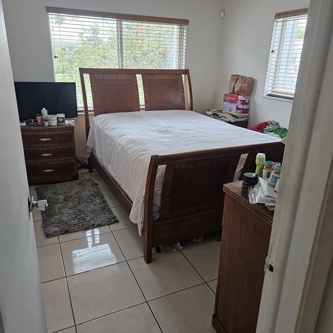7202 Northwest 73rd Street Tamarac, FL 33321 - Photo 5 of 11 a bedroom with a bed and a window