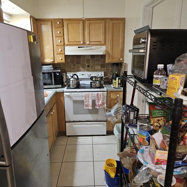 7202 Northwest 73rd Street Tamarac, FL 33321 - Photo 6 of 11 a kitchen with stainless steel appliances a stove a sink and a refrigerator