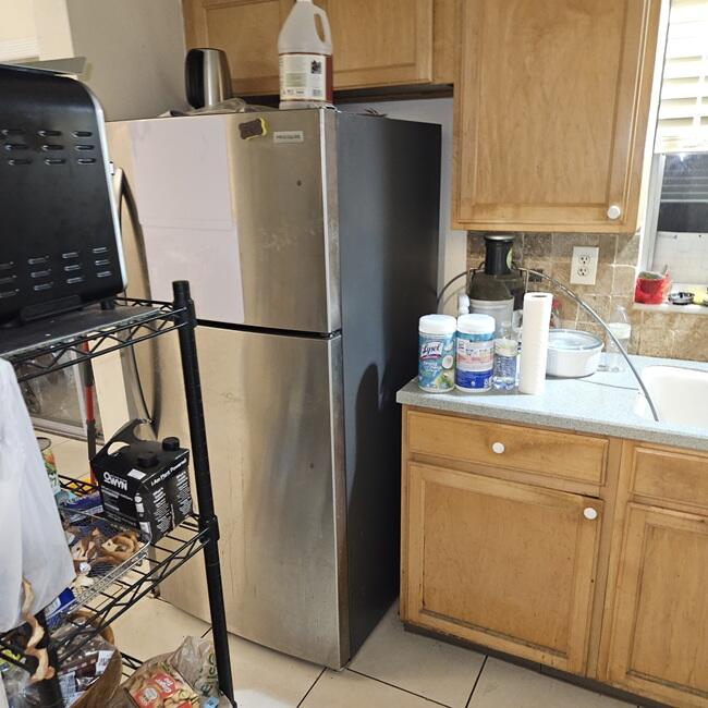 7202 Northwest 73rd Street Tamarac, FL 33321 - Photo 7 of 11 a white refrigerator freezer sitting inside of a kitchen