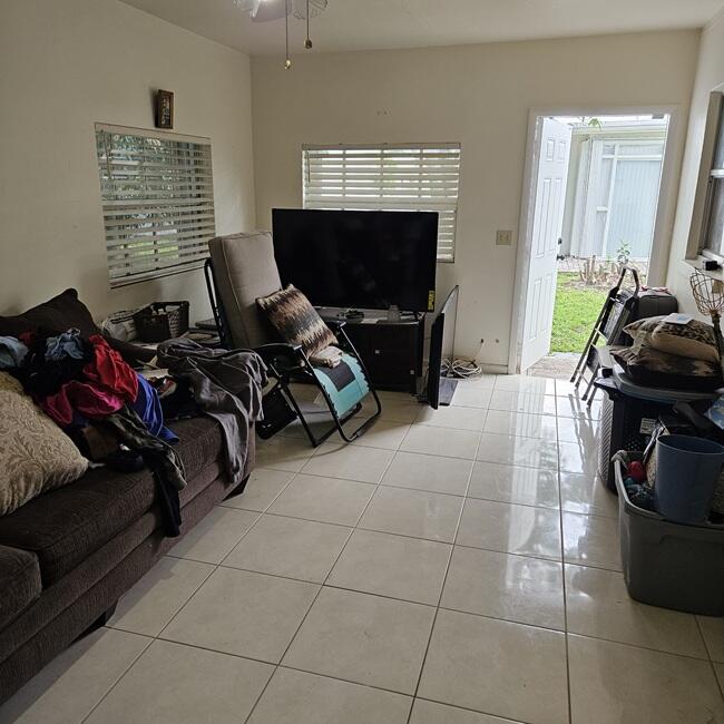 7202 Northwest 73rd Street Tamarac, FL 33321 - Photo 10 of 11 a living room with furniture a flat screen tv and a fireplace