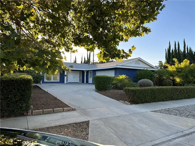 a view of a house with a tree in the yard
