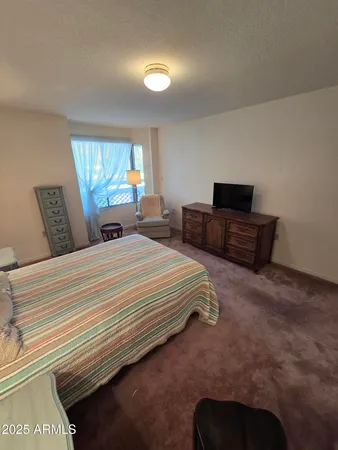 a bedroom with bed and window